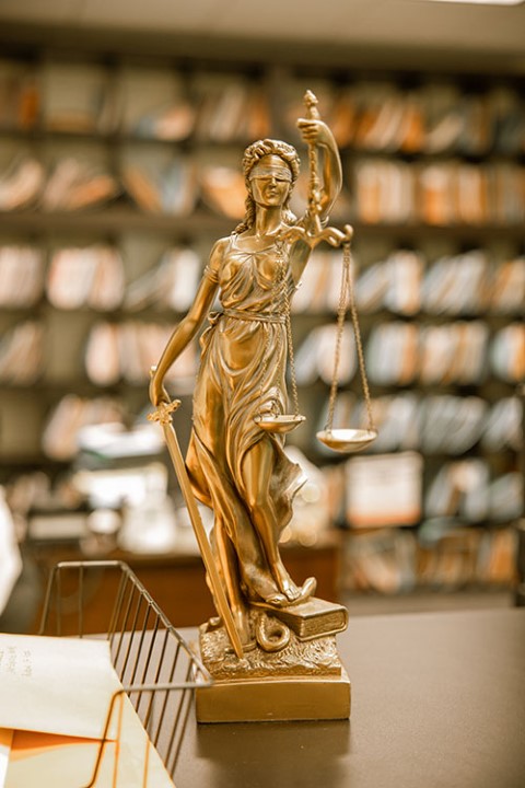Justice statue in Burgis Law office symbolizing legal integrity